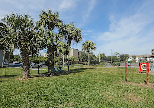 A park with a red pole and a green bench. at Sarasota South Apartments, Bradenton, 34207