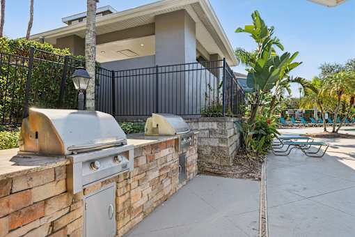 Outdoor grilling stations with built in bbq grills at The Arbor Walk Apartments, Tampa, Florida