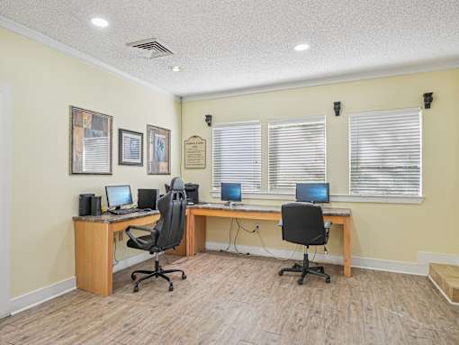 A room with two desks and two chairs. at Cedar Springs Apartments, Raleigh, NC