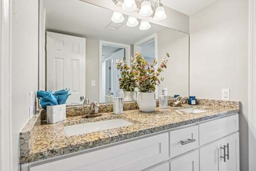 a bathroom with a sink and a mirror at The Glen at Highpoint, Dallas, 75243