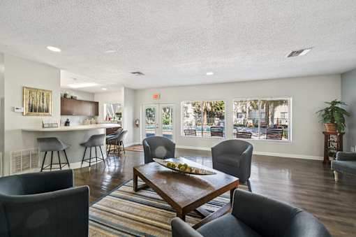 A living room with a brown table and grey chairs. at Sarasota South Apartments, Florida, 34207