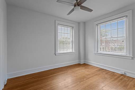 A room with a ceiling fan and two windows.at The Collection of Historic Richmond, Richmond Virginia