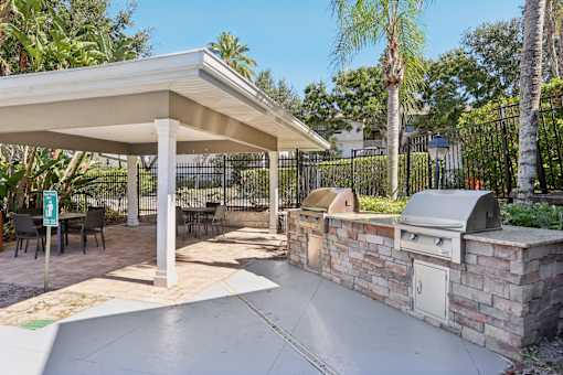 Outdoor kitchen with covered pavilion and grills at The Arbor Walk Apartments, Tampa