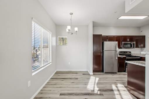 A kitchen with a refrigerator, microwave, and oven at Sweetwater At Metro North Apartments, Phoenix