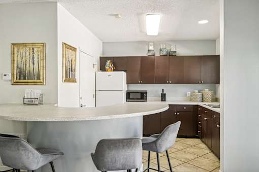 A kitchen with a white counter and brown cabinets. at Sarasota South Apartments, Bradenton, Florida