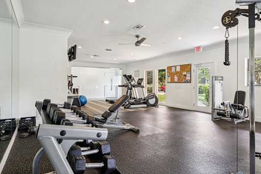 A gym with a variety of equipment including weights and machines. at Lakeside Glen Apartments, Florida
