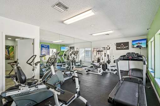 A gym with treadmills, exercise bikes, and other equipment. at Sarasota South Apartments, Bradenton, 34207