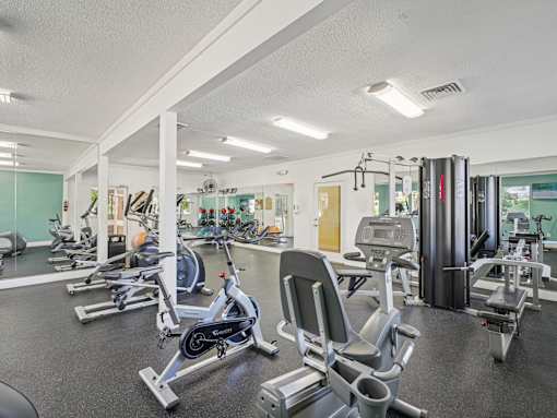 A gym with a row of exercise bikes. at Cedar Springs Apartments, Raleigh, North Carolina