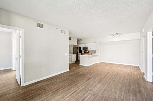 A large empty room with wood flooring and white walls. at Heritage Bay, Florida, 34957