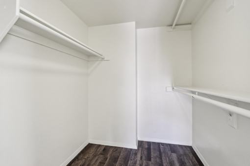 A white room with a wooden floor and a white door at Del Coronado Apartment , Arizona, 85202