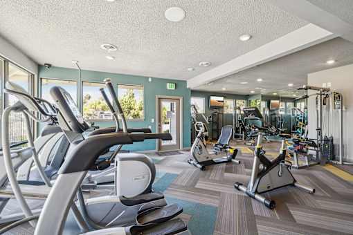 A gym with treadmills, elliptical machines, and other exercise equipment at Union Heights Apartments, Colorado Springs, Colorado