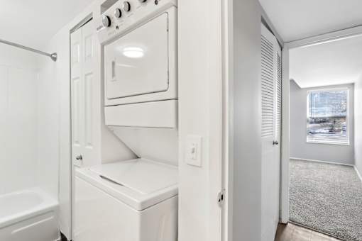A white oven and microwave are built into a wall in a kitchen. at Millennium at Creve Coeur, Missouri