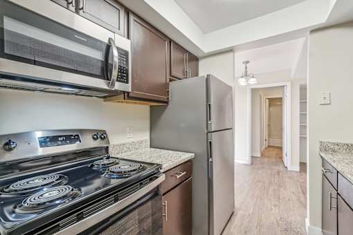 A kitchen with a stove, oven, microwave, and refrigerator. at Cliffs at Canyon Ridge, Utah, 84401