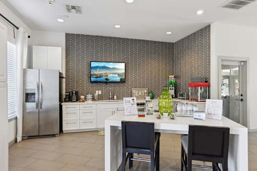 Community kitchen with herringbone tile backsplash at The Arbor Walk Apartments, Tampa, Florida
