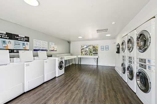 A laundry room with washing machines and a sign that says  at Sarasota South Apartments, Florida, 34207