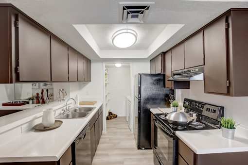 a kitchen with dark cabinets and white countertops at Glen at Mesa Apartments, AZ 85201