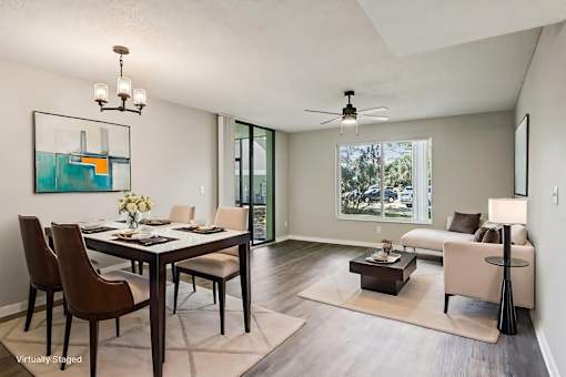 A modern dining room with a glass table and chairs. at Lakeside Glen Apartments, Florida, 32904