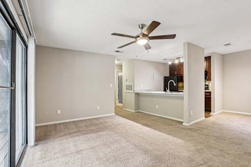 A spacious room with a ceiling fan and carpeted floor. at Canopy Glen, Norcross, GA, 30093