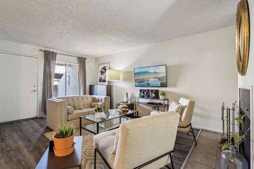 A living room with a couch, chairs, and a coffee table at Del Coronado Apartment , Mesa