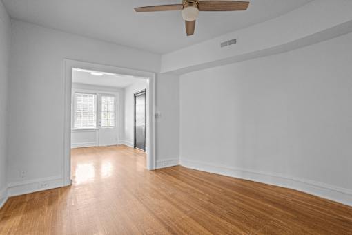 A room with a ceiling fan and wooden floors.at The Collection of Historic Richmond, Richmond, VA 23220