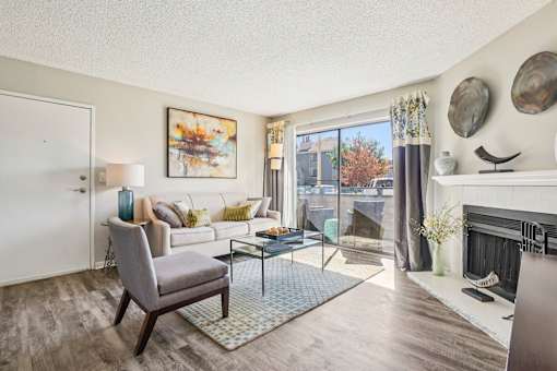 Living Room With Balcony at Deer Crest Apartments, Broomfield, CO