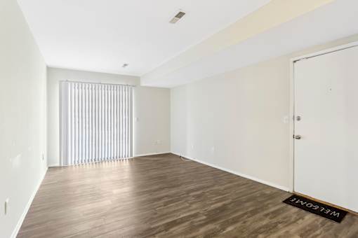 A room with wooden flooring and a white door. at Millennium at Creve Coeur, Missouri, 63141
