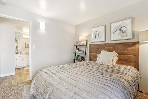 A bedroom with a large bed and two pictures on the wall. at Cliffs at Canyon Ridge, Utah, 84401