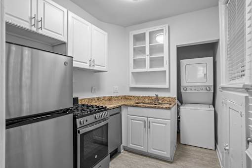 A kitchen with a stove, oven, and refrigerator.at The Collection of Historic Richmond, Richmond