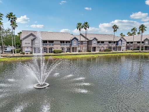 A fountain in the foreground of a building complex at The Parkway at Hunters Creek, Orlando, 32837