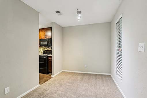 A room with a carpeted floor and a ceiling fan. at Canopy Glen, Norcross, Georgia