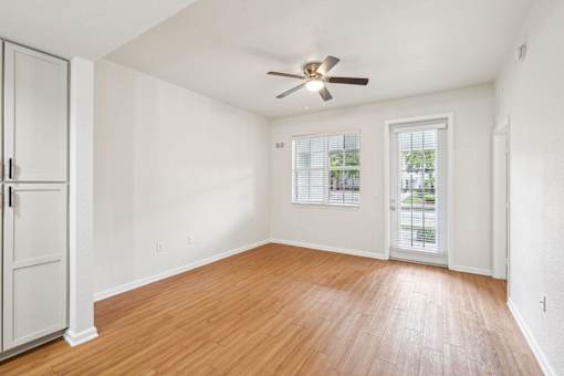 A room with a ceiling fan and wooden flooring. at The Dakota, Florida, 33458