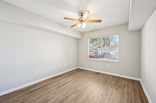 A room with a ceiling fan and a window with blinds. at Heritage Bay, Jensen Beach