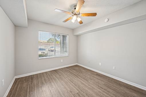 A room with a ceiling fan and a window with blinds. at Heritage Bay, Jensen Beach, 34957