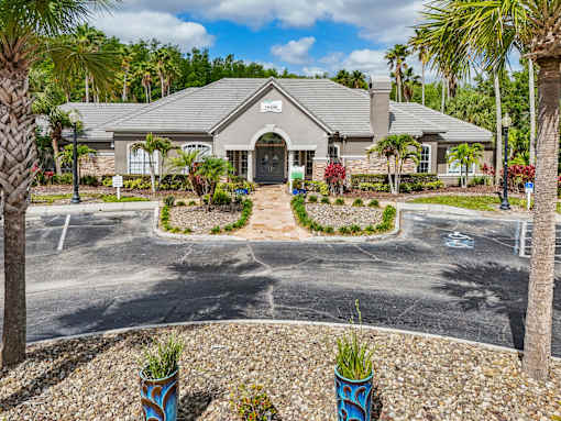 A building with a grey roof and a sign on it at The Parkway at Hunters Creek, Orlando, 32837