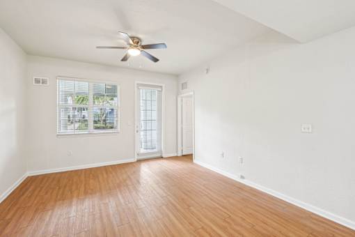 A room with a ceiling fan and wooden flooring. at The Dakota, Jupiter, Florida