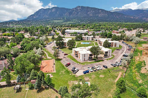 A bird's eye view of a small town with a large mountain in the background at Broadmoor Springs, Colorado Springs, CO, 80906