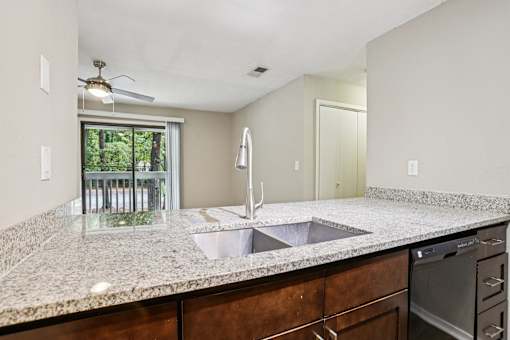 A kitchen with granite countertops and stainless steel appliances. at Canopy Glen, Georgia, 30093