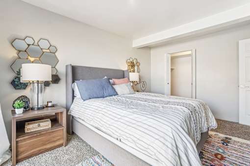 A bedroom with a bed, nightstand, and lamp. at Cliffs at Canyon Ridge, Utah, 84401