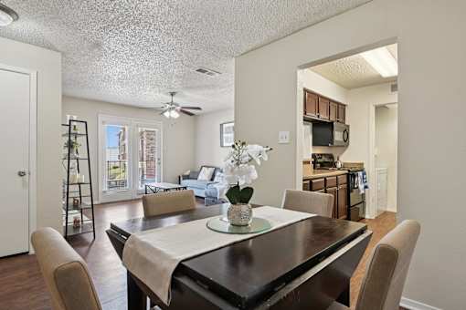 A dining room with a table set for two.