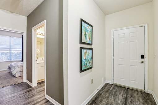 Entryway with framed artwork and bedroom access at The Arbor Walk Apartments, Tampa, FL 33617