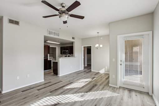 A room with a ceiling fan and wooden flooring at Sweetwater At Metro North Apartments, Phoenix