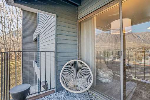 A white fan is on a patio with a view of the mountains. at Cliffs at Canyon Ridge, Utah, 84401