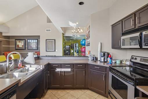 A kitchen with brown cabinets and a black stove top oven.