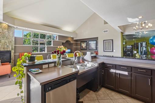 A modern kitchen with a large island and a dining area.