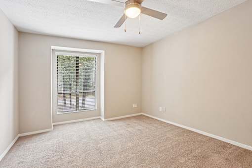 A room with a ceiling fan and a window with blinds. at Canopy Glen, Norcross, GA