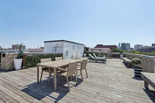 Rooftop deck with wooden table and chairs at The View at Old City, Philadelphia, 19106