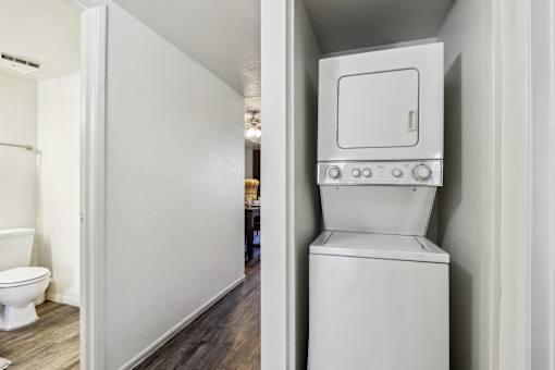 A white toilet with a tank built into a wall at Del Coronado Apartment , Mesa