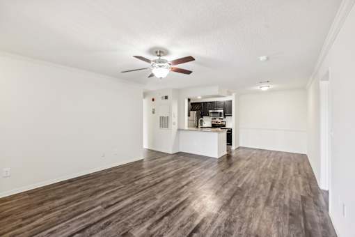 A room with a ceiling fan and wooden flooring at The Parkway at Hunters Creek, Orlando, 32837