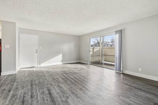 A spacious room with a grey floor and white walls at Spyglass Creek, Denver, 80224