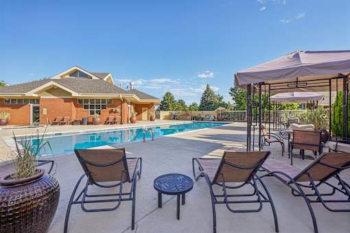 A house with a pool and patio furniture.